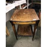 A Victorian inlaid tea trolley with drop leaves.