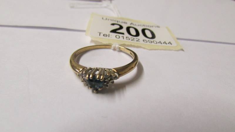 A 9ct gold diamond and topaz dress ring, size T.