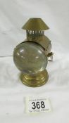 A novelty Edwardian brass inkwell in the form of a coach lamp.