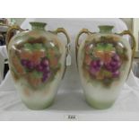 A pair of 29cm tall flasks with 2 shoulder handles decorated with grapevine.