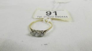 An 18ct yellow gold 3 stone diamond 35pt ring, size P.