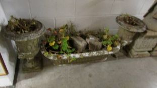 Two early stone urns and a garden trough.
