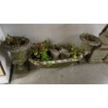 Two early stone urns and a garden trough.