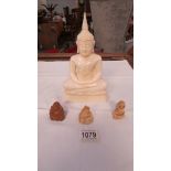 A Resin Buddha and 3 smaller examples.