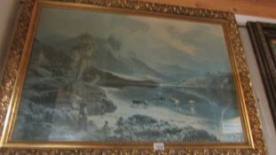 A large gilt framed and glazed print of a mountain scene.