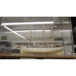 A large cased model three mast sailing boat.