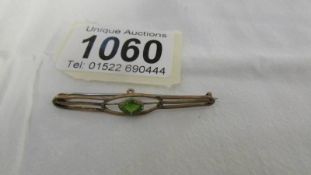 A Victorian gold bar brooch set peridot.