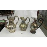 Three silver plate coffee pots.