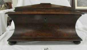 An impressive Georgian rosewood tea caddy with inset storage boxes on bun feet, 16" wide,