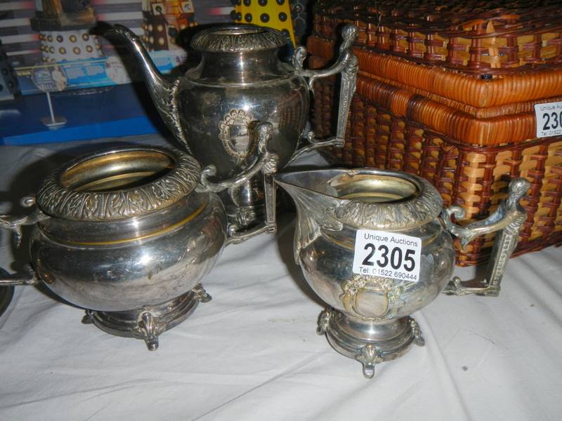An unusual 3 piece pewter tea set with figural handles. (missing lids).