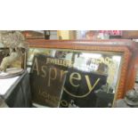 An overmantel mirror with Asprey signage.