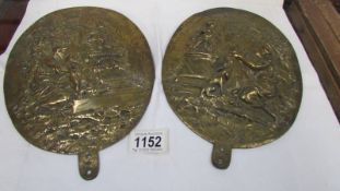 A pair of old oval brass plaques.