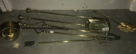 A set of brass fire irons, toasting fork etc.