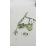 3 items of white metal green stone set jewellery being pendant with matching bracelet and brooch.