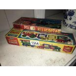 A boxed Merit travelling circus and a boxed tinplate friction police helicopter.