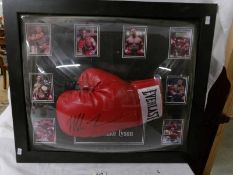 A framed signed boxing glove 'Iron' Mike Tyson with certificate of authentication.