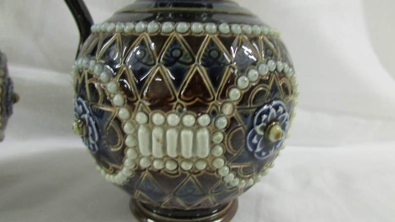A pair of 16.5 cm Doulton ewers by E Violet Haywood, Minnie Forster and N Taylor. - Image 3 of 4