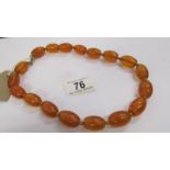 A large bead amber necklace with 9ct gold clasp.