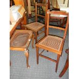 A pair of cane seated bedroom chairs and a stool.