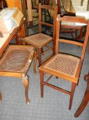 A pair of cane seated bedroom chairs and a stool.