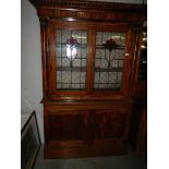 A glazed top display cabinet with leaded glass doors.