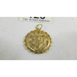 A pendant (test and 24 ct gold) 2.6 grams.