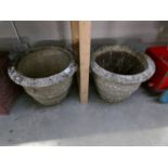 A pair of large concrete garden pots.