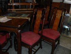 A large extending mahogany dining table with 2 leaves and a set of 8 chairs.