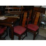 A large extending mahogany dining table with 2 leaves and a set of 8 chairs.