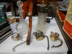 A claret jug and 3 plated claret jug tops.