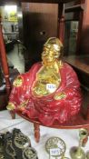 A gilded porcelain figure of Buddha.