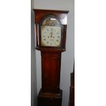 An early 19th century oak long case clock with a painted arch dial.