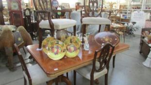 A superb quality double pedestal dining table with 6 shield back dining chairs.