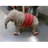 A 19/20th century pull along elephant toy on wheels.