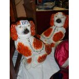 A pair of Victorian Staffordshire spaniels (hair line cracks).