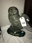 A metal doorstop of an owl.