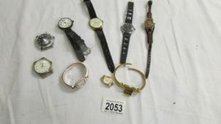 A mixed lot of vintage watches and watch heads.
