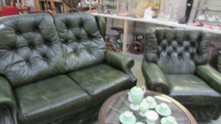 A green leather 2 seat sofa and chair.