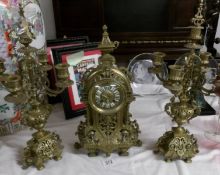 A 3 piece brass clock garniture.