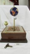 An unusual gem stone globe with moon and sun mantel clock.