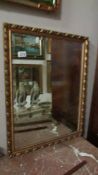 A bevel edged gilt framed mirror.