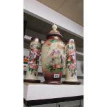 A large Victorian hand painted lidded vase and a pair of tall Victorian hand painted vases.