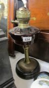 A Victorian oil lamp base with glass font and complete with burner.