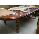 A large oval mahogany extending dining table.