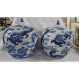 A striking pair of large blue and white lidded porcelain melon ginger jars with dragons chasing