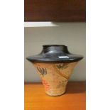 A heavy ceramic lidded pot.