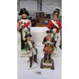 A ceramic decanters in the form of 18th century soldiers and 2 soldier figures.