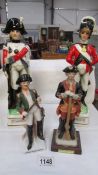 A ceramic decanters in the form of 18th century soldiers and 2 soldier figures.