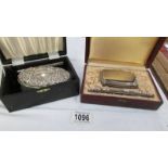 2 boxed silver backed brush and comb sets.