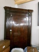 A Victorian corner cupboard with shell inlay.